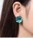 Groenblauwe oorclips met helderpaars strass steentje