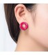 ronde oorclips met fuchsia roze inleg in een zilverkleurige zetting