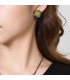 Gele ronde oorclips in een gun black zetting